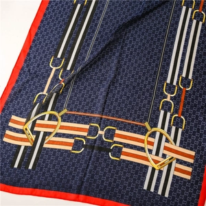 Detail of silk scarf showing equestrian pattern with horse bits and chain prints