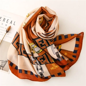 Detail of soft cotton linen shawl with geometric letter patterns and stripe borders