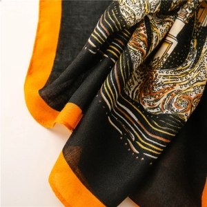 Detailed macro view of retro print scarf showing fine fabric texture and orange borders