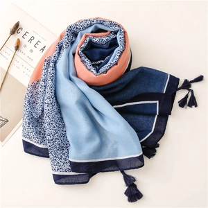 Detail of blue and orange floral cotton linen scarf with elegant tassel fringe