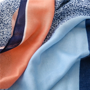 Detail view of the colorful cotton linen scarf showing soft fabric texture and fringe