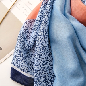 Detail of color-blocked cotton linen scarf with leopard print and fringe texture