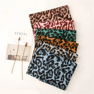 Detail of colorful leopard print scarves in soft linen-feel fabric neatly stacked