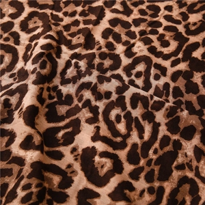Macro shot of brown leopard print texture and soft fabric fibers on the scarf