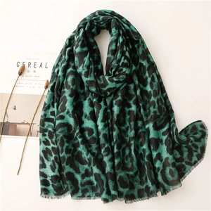 Detail of green and black leopard print scarf with textured fringe and cotton-linen feel