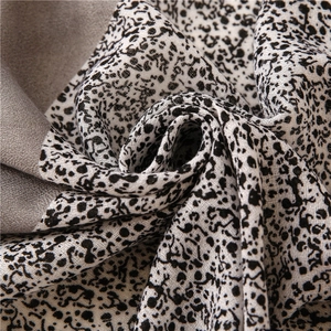 Detail of soft cotton-linen scarf showing black and white leopard print and grey border