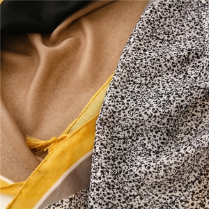 Detailed view of color-blocked cotton linen scarf with fringe tassels and ethnic prints