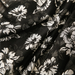 Macro detail of breathable black and white tropical floral pattern cotton linen fabric