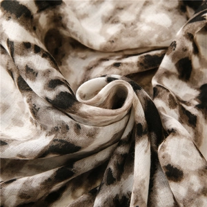 Detailed macro view of soft leopard print fabric with breathable plain weave texture
