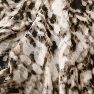 Macro shot of thin leopard print fabric with soft texture and detailed weave