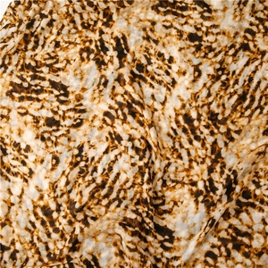 Detailed close-up of soft leopard print fabric texture with elegant silky brown waves