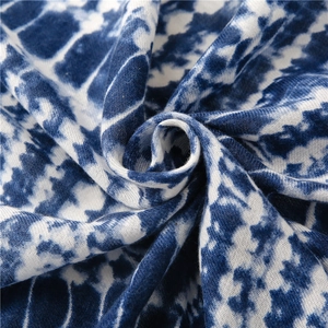 Detail of blue and white tie-dye cotton scarf fabric with soft twisted texture