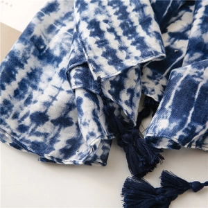 Close-up of blue and white tie-dye cotton scarf with handcrafted long fringe detail