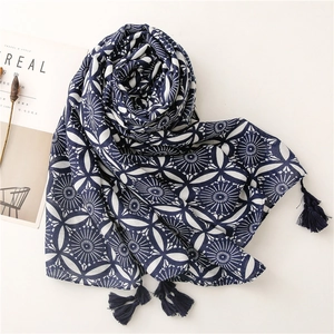 Ethnic retro blue and white porcelain pattern scarf with navy tassels on white surface