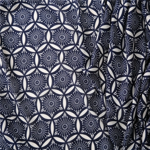 Macro detail of navy and white kaleidoscope floral print on cotton linen fabric texture