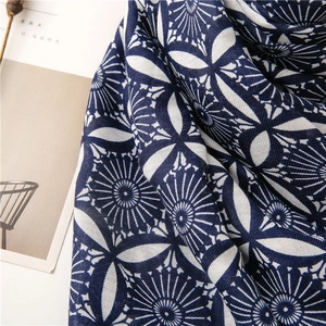 Detailed close-up of blue and white geometric floral pattern on cotton linen scarf