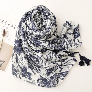 Ethnic blue floral cotton linen scarf with tassels and leaf print on white fabric