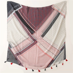 Detail of nautical anchor print on red and blue paneled scarf with fringe trim