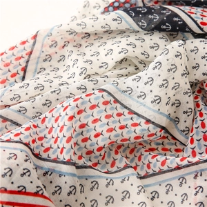 Detail view of cotton linen scarf showing soft fabric texture with anchor and fish prints