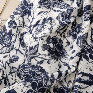 Detailed macro view of ethnic blue and white floral pattern on soft cotton linen scarf