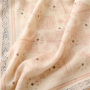 Macro shot showing cotton-linen fabric texture with orange geometric diamond print pattern