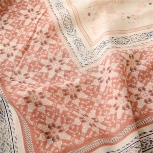 Macro detail of geometric print scarf showing soft cotton-linen fabric texture