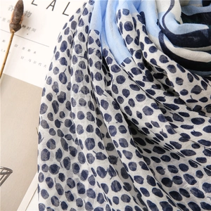 Detailed macro view of blue leaf pattern on lightweight cotton linen scarf with soft texture