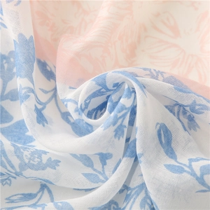 Lightweight cotton-linen feel scarf with blue and pink leaf prints and tassel details