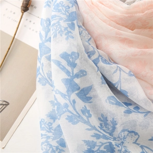 Macro detail of breathable leaf print scarf fabric with fine weave and sheer texture