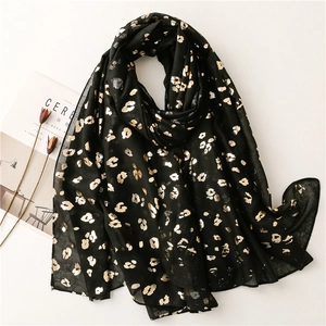 Lightweight black bali yarn scarf with golden leopard print and frayed edges