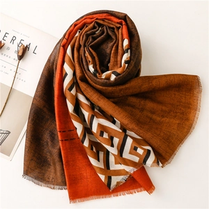 Macro shot of colorful geometric spliced scarf with fringe edges and soft texture