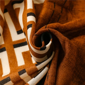 Detailed macro view of caramel and white thick woven scarf with frayed edge texture