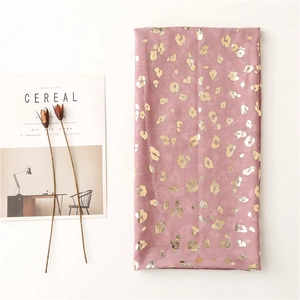Detail of pink leopard print scarf with gold foil texture and dry flower decoration