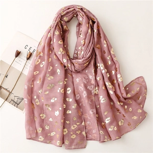 Detail of pink lightweight scarf with gold leopard foil print and soft texture
