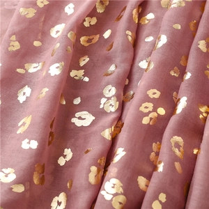 Close-up of pink bali yarn scarf featuring gold foil leopard print and soft texture