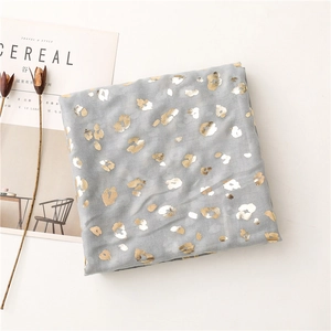 Detail of grey scarf with gold and silver foil leopard print and soft texture