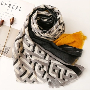 Detail of color-block scarf with geometric patterns and soft fringed edges