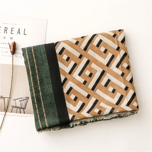 Detail of color-block geometric scarf with raw edges, laid with Cereal magazine