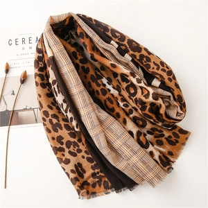 Leopard print and classic plaid patchwork scarf with frayed edges in warm earth tones