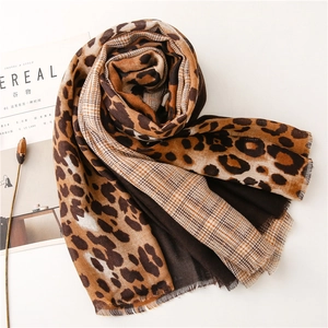 Detail of leopard print and houndstooth pattern scarf with soft fringed edges