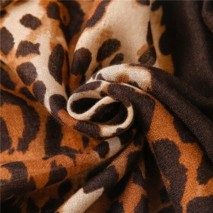 Close-up of leopard print scarf fabric showing soft cotton linen texture and weave