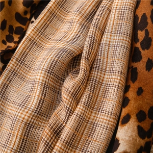 Macro shot of cotton linen scarf showing leopard print and houndstooth texture detail