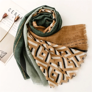 Detail of multi-color geometric shawl featuring frayed edges and textured fabric
