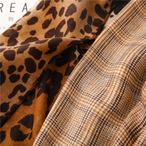 Close-up of leopard print and houndstooth pattern patchwork on soft cotton linen scarf