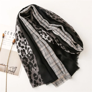 Close-up of leopard print and plaid stitching scarf with delicate fringe details