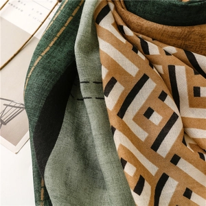 Detail of multi-color woven scarf featuring geometric patterns and soft fringed edges