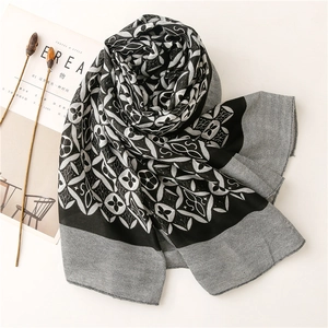 Black and white kaleidoscope clover pattern cotton linen scarf shawl displayed on white surface