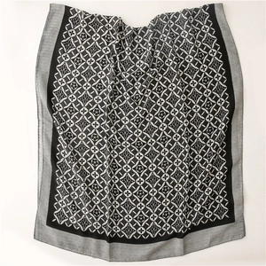 Detail of kaleidoscope geometric pattern on black and white linen-feel scarf wrap