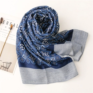 Detail of blue and white kaleidoscope print scarf with herringbone edge and silk texture