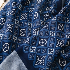 Close-up of kaleidoscope pattern on navy blue linen-feel scarf with intricate details